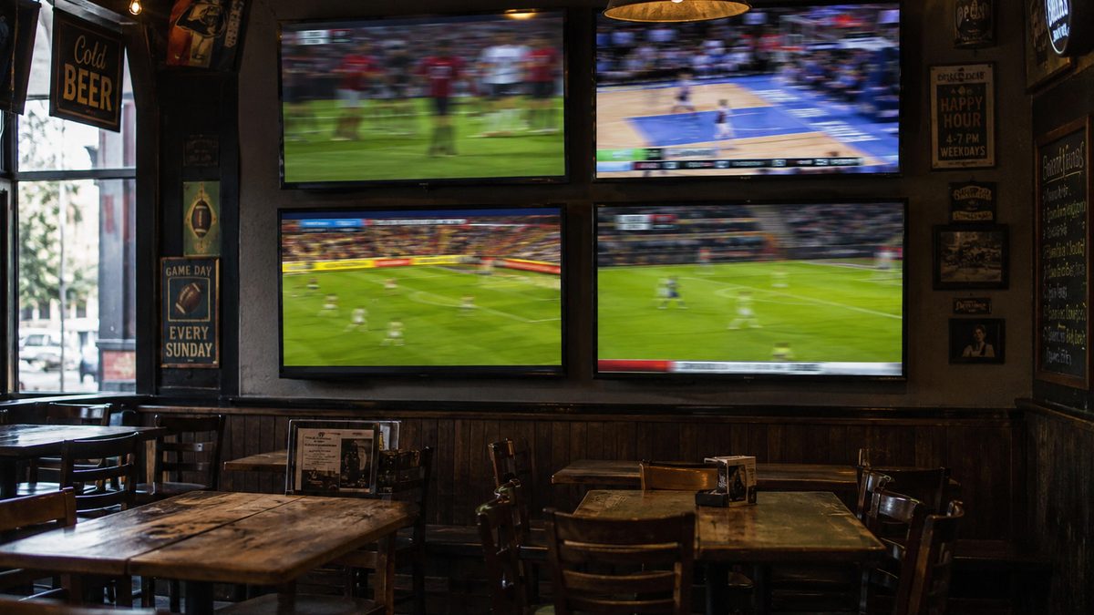 Sports bar interior with several screens showing different live matches